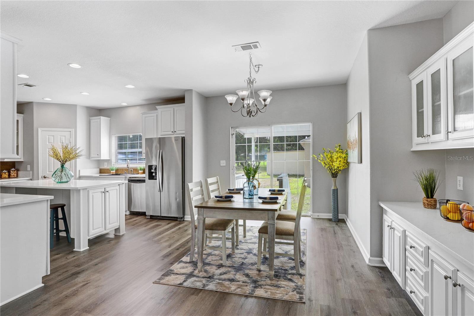 The sliding glass door leads to the back porch area and detached office/garage.