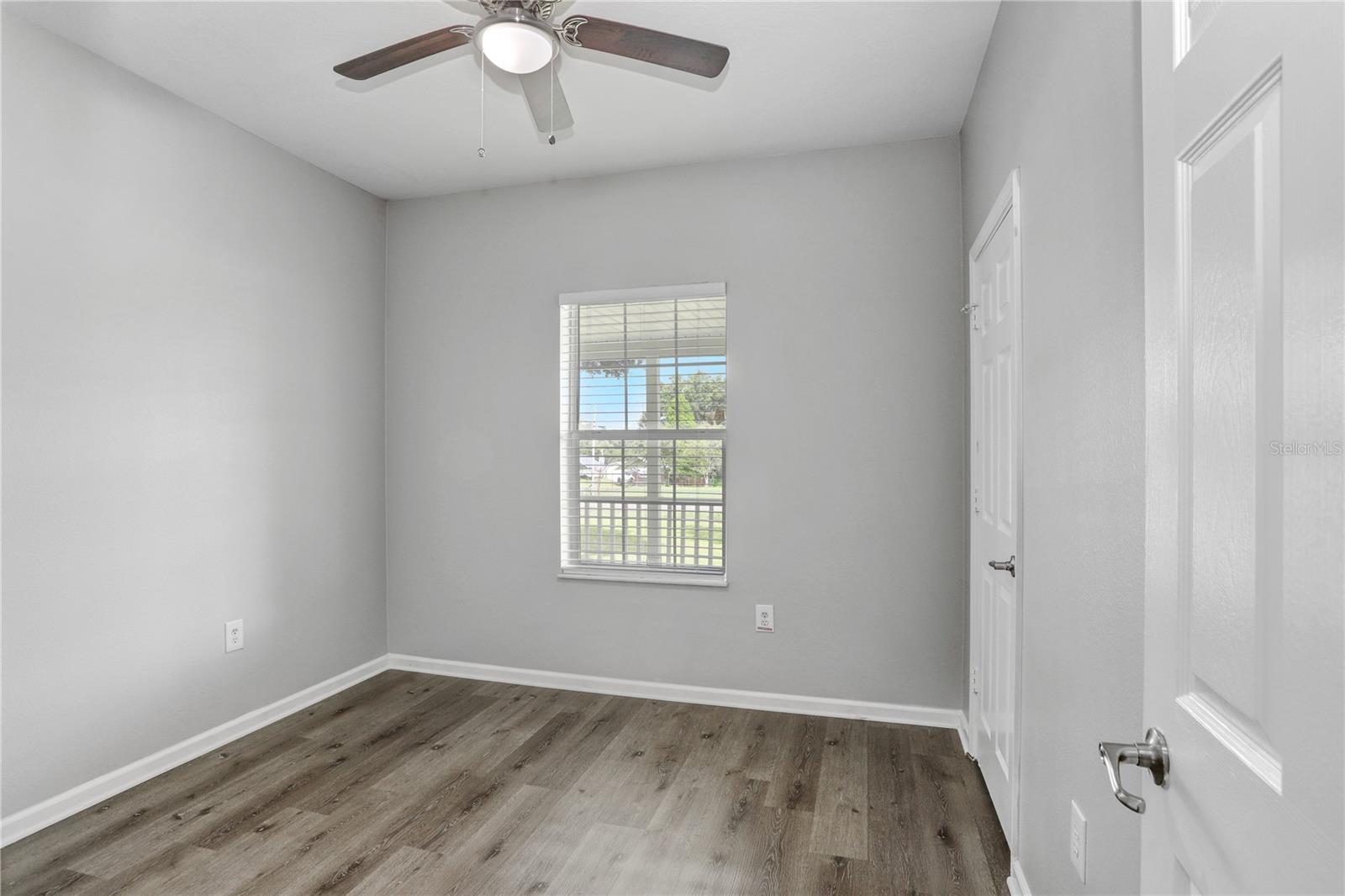 Bedroom 2 with lighted ceiling fan.