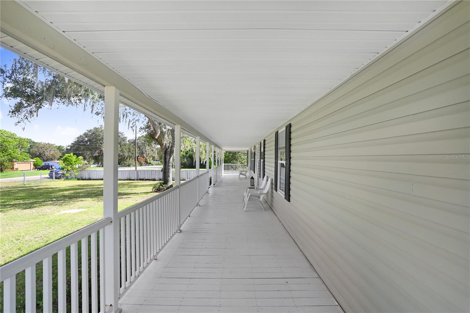 Look at this gorgeous front porch that faces East!  Some couches and/or a table with chairs could be added for relaxation on those mornings where you'd like to sip your coffee and watch the sunrise.