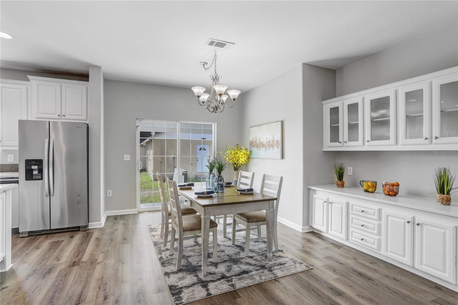 The kitchen has an eat-in space that can accommodate a huge table!  Next to it is a built-in buffet with several drawers, cabinets, and beautiful glass cabinets.