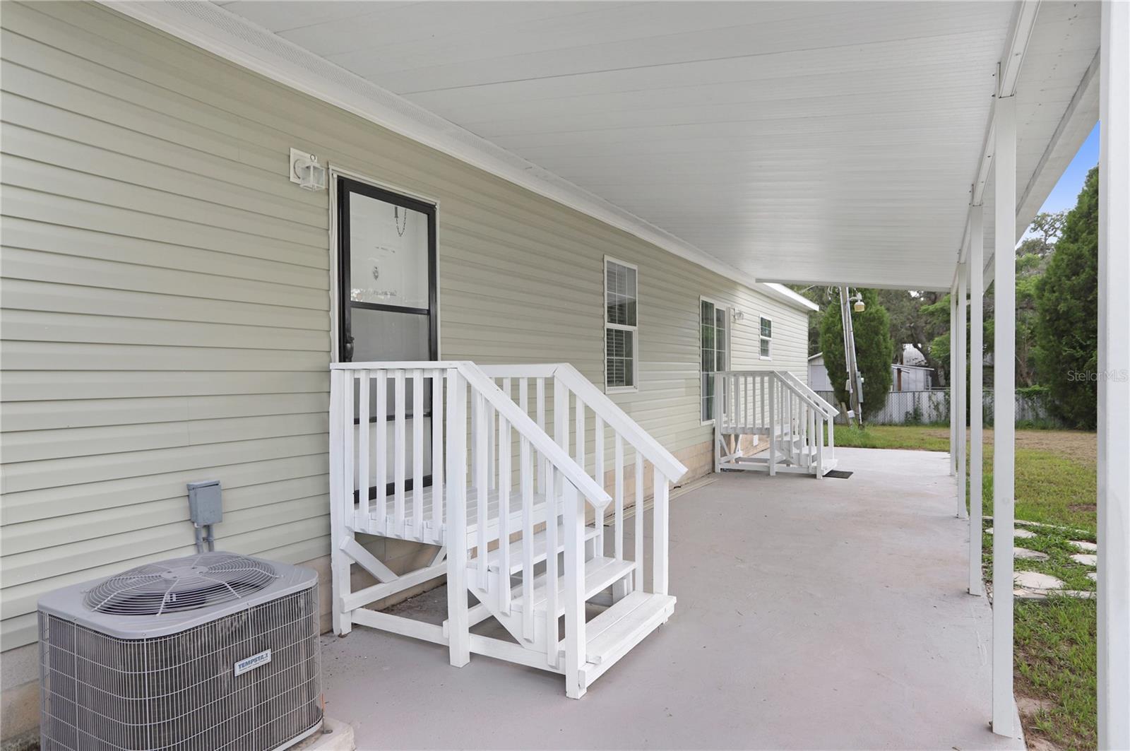 The extremely large, covered back porch has a hot tub hookup.  The stones to the right lead to the detached office.