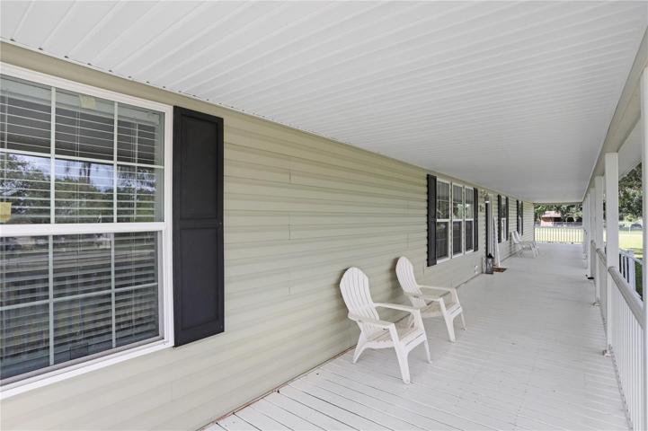 Look at this gorgeous front porch that faces East!  Some couches and/or a table with chairs could be added for relaxation on those mornings where you'd like to sip your coffee and watch the sunrise.