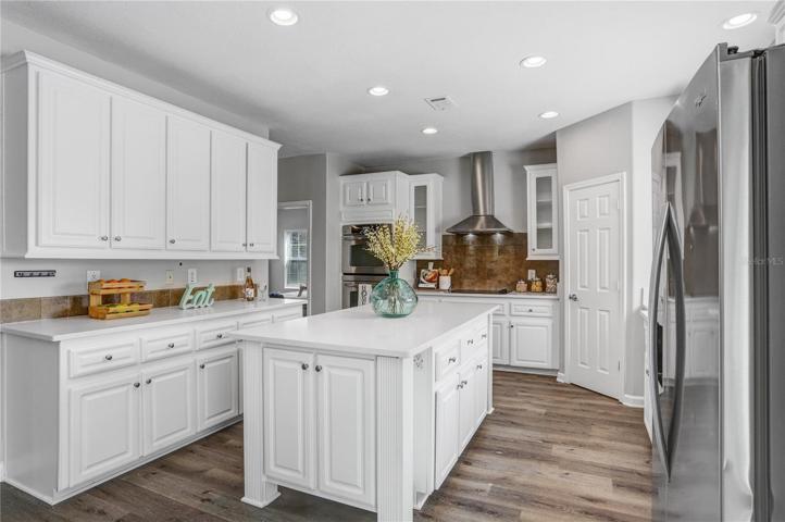 The kitchen is a chef's dream!  Lots of counter and cabinet space....all stainless appliances....a double over.....a cooktop and beautiful range hood and lots of overhead lighting!!!