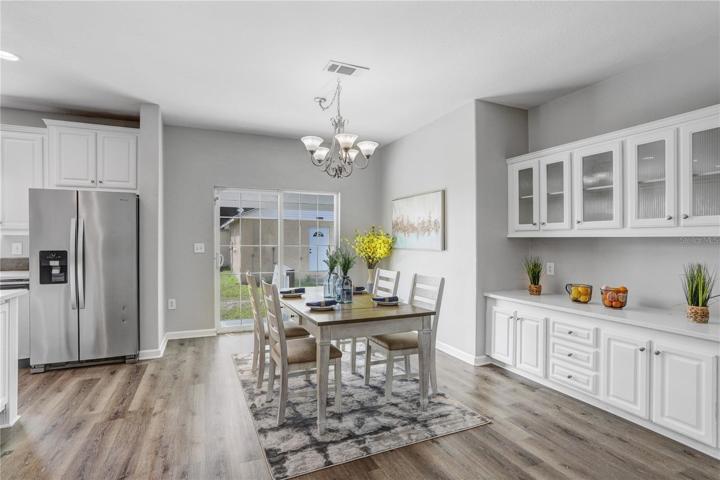 The kitchen has an eat-in space that can accommodate a huge table!  Next to it is a built-in buffet with several drawers, cabinets, and beautiful glass cabinets.