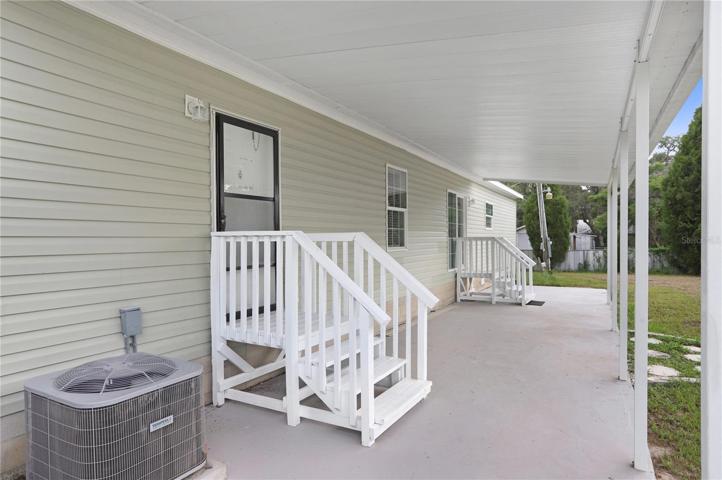 The extremely large, covered back porch has a hot tub hookup.  The stones to the right lead to the detached office.