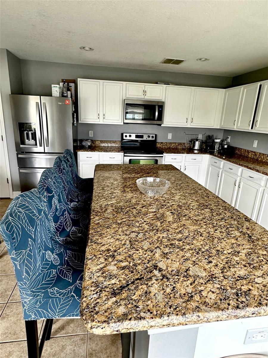Oversized granite island in kitchen