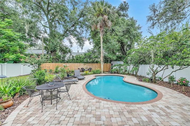 Brick paver decking surrounding pool