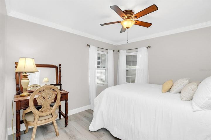 Bedroom 2 has crown molding and laminate floors