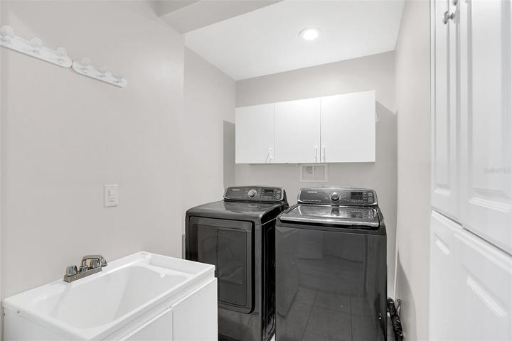 Laundry room with cabinetry & utility sink