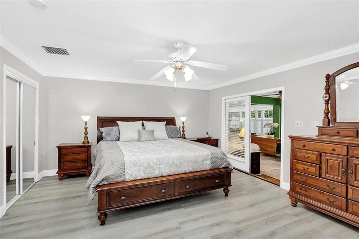 Owners suite with crown molding, laminate flooring & huge walk-in closet