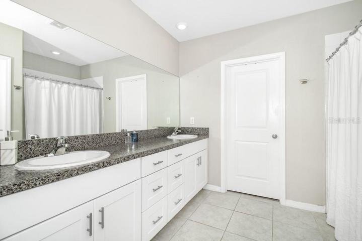 Master Bedroom's en-suite bathroom with a dual vanity and a step-in shower.
