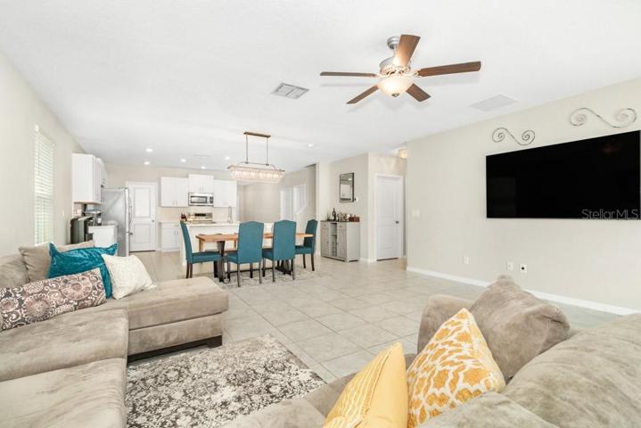The open-concept design seamlessly flows into the dining area/ large family room combo providing an ideal setting for gatherings and relaxation.