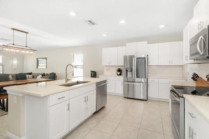 The breakfast bar invites you to enjoy casual meals, while the walk-in pantry ensures ample storage space for all your culinary needs.