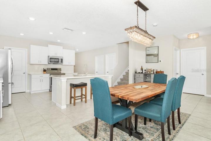 The open-concept design seamlessly flows into the dining area/ large family room combo providing an ideal setting for gatherings and relaxation.