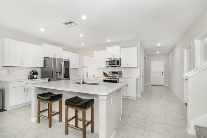 Step inside and be greeted by the high ceilings and a chef's kitchen that dreams are made of!