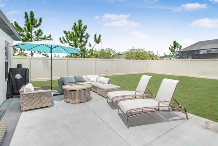 The sliding glass doors beckon you to the new and expansive large concrete back patio and partially fenced-in backyard.