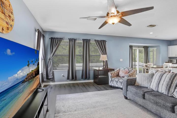 The family room overlooks the lanai & private conservation views
