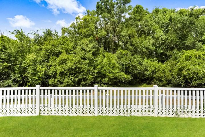 The yard is fully fenced with privacy fencing on both sides.