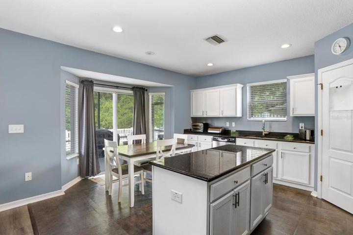 The kitchen is adjacent to the family room and leads out to the back lanai