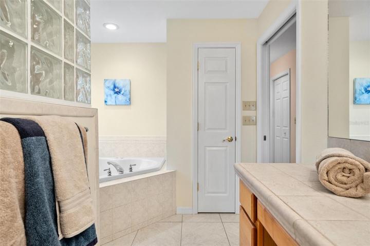 Spacious upstairs owner's suite featuring a luxurious bathroom complete with a Jacuzzi tub and a separate standing shower.
