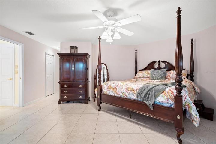 Spacious upstairs owner's suite featuring a luxurious bathroom complete with a Jacuzzi tub and a separate standing shower.