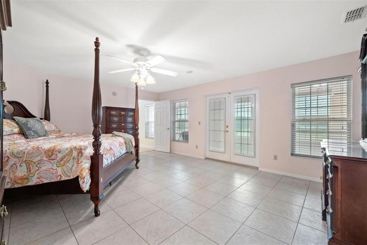 Spacious upstairs owner's suite featuring a luxurious bathroom complete with a Jacuzzi tub and a separate standing shower.