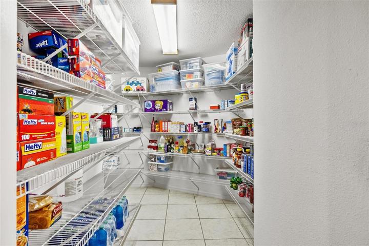 Spacious pantry offering abundant storage for food and culinary equipment.