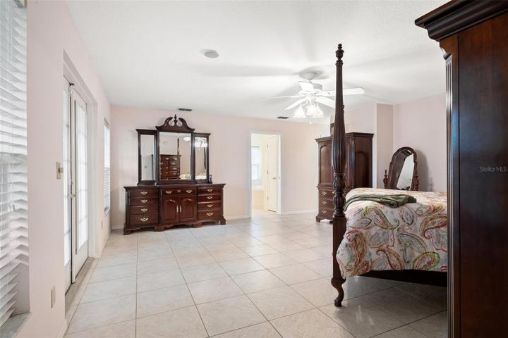 Spacious upstairs owner's suite featuring a luxurious bathroom complete with a Jacuzzi tub and a separate standing shower.