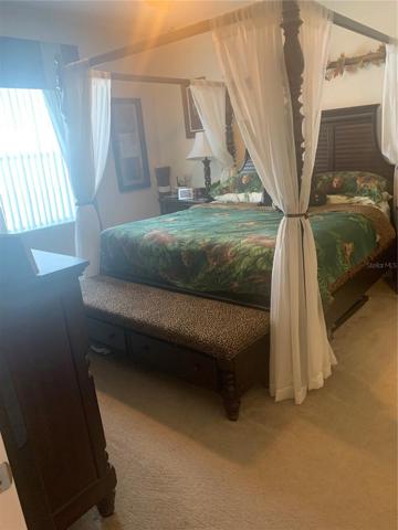 Master bedroom with double window looking into pool deck