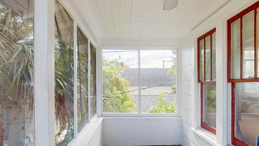 Screened porch on upper garage apartment.