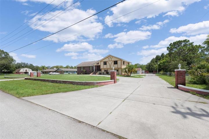 long driveway and parking pad.