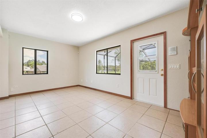 office off kitchen with door leading out to pool enclosure