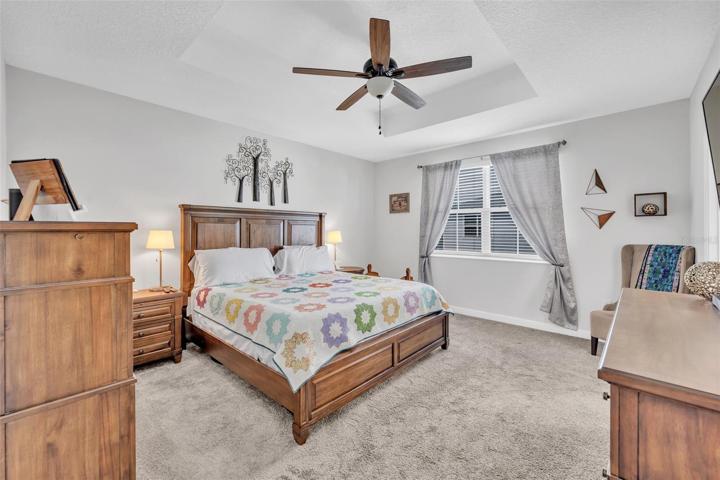Spacious Primary Bedroom... Note Tray Ceilings and ceiling Fan
