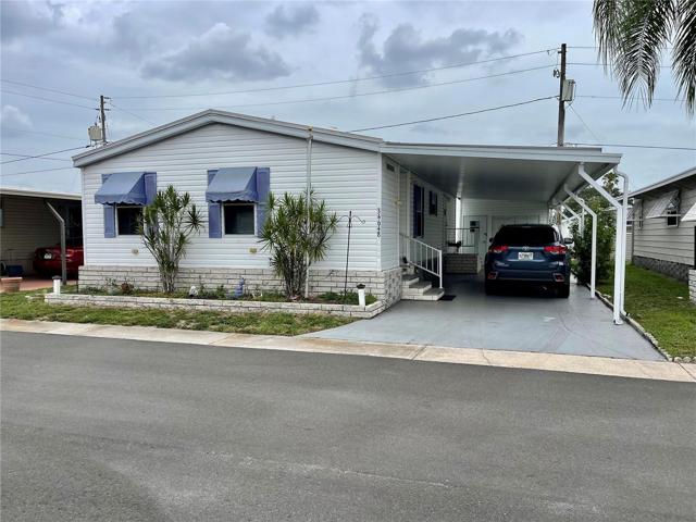 Front of the home, newer roof over in 2019, notice the carport extenders.