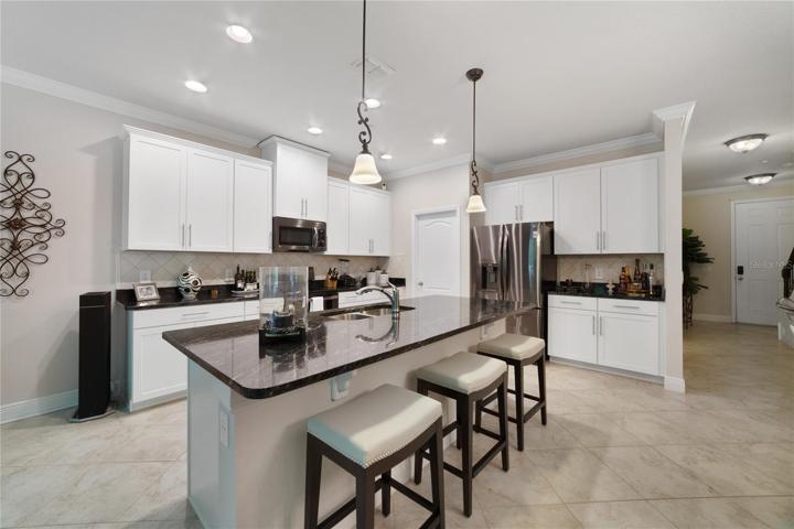 The kitchen was designed with the home chef in mind and features UPGRADED GRANITE COUNTERTOPS and backsplash, a closet pantry for ample storage, HIGH-END APPLIANCES and a large ISLAND with breakfast bar seating for casual dining with family or entertaining friends!