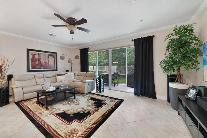 This immaculately maintained home delivers a bright OPEN CONCEPT with TILE FLOORS in the main living area, CROWN MOLDING and motorized shades on your OVERSIZED SLIDING GLASS DOOR!