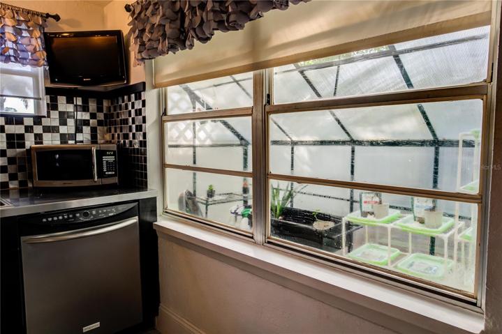 Easy to check on your green house herbs and flowers from the kitchen
