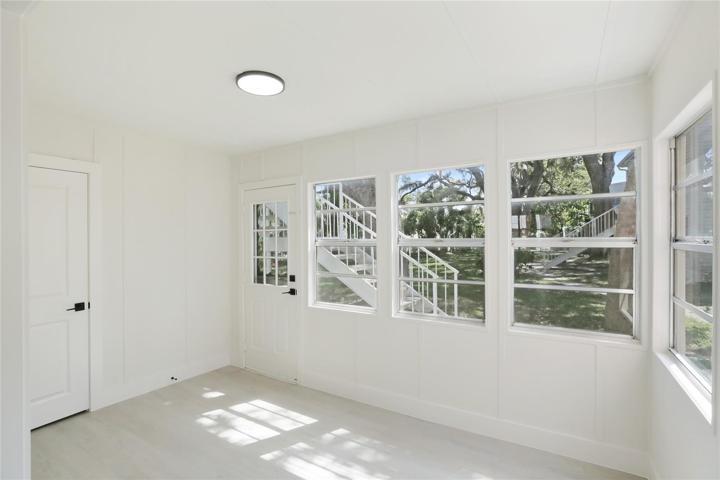 The Florida room provides access to both the laundry closet and the back yard.