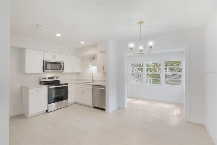 A bonus feature of this condo is the sunroom off the dining area, a versatile space perfect for unwinding with a book or working from home.