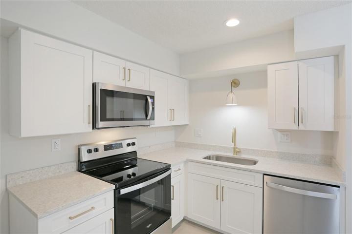 Step inside to luxury vinyl tile flooring leading to a fully updated kitchen.