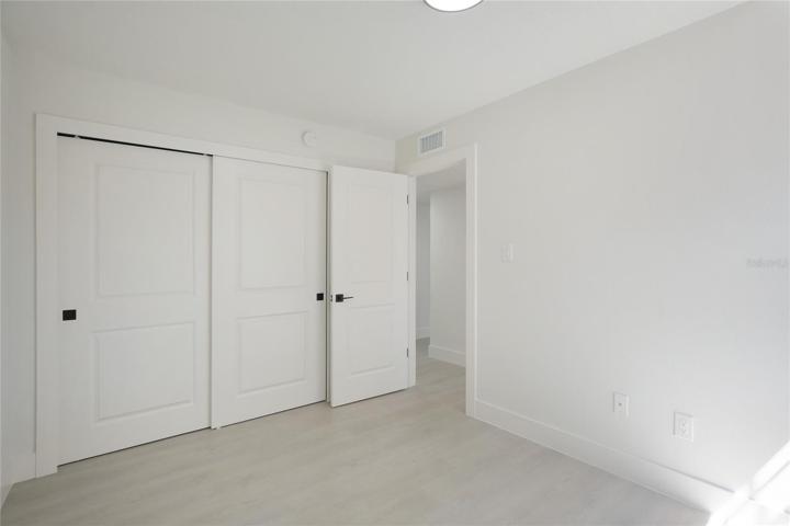A different perspective of the guest room highlighting its new doors and moldings.
