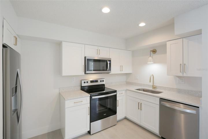 Welcome to your own paradise - a beautifully updated two-bedroom, one-bath condo on the first floor!