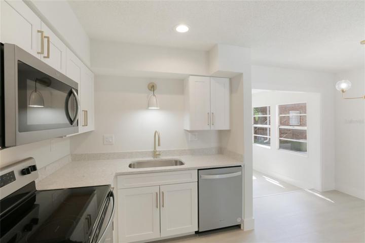 White shaker style cabinets keep the kitchen light and bright.