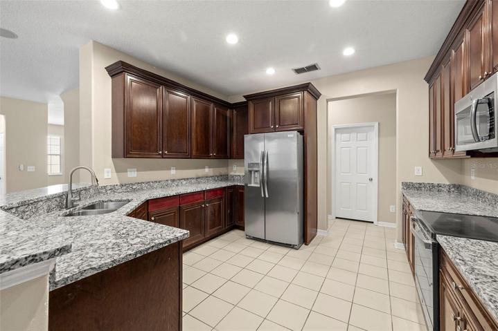 KITCHEN and BREAKFAST-NOOK with Breakfast-Bar and French-Doors to Pool and Extended Lanai