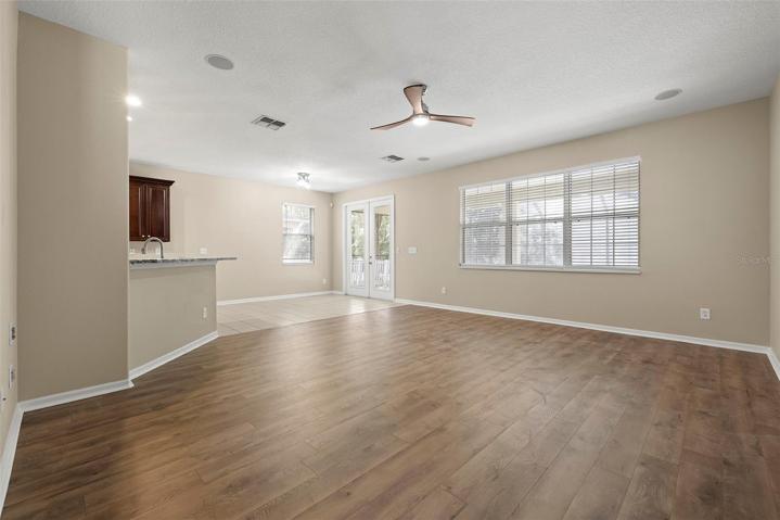 FAMILY ROOM with Breakfast-Bar, BREAKFAST-NOOK, and French Doors to Pool and Extended Lanai