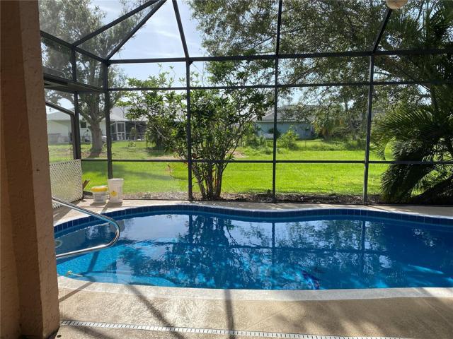 Greenbelt behind home with pool and spa under cage