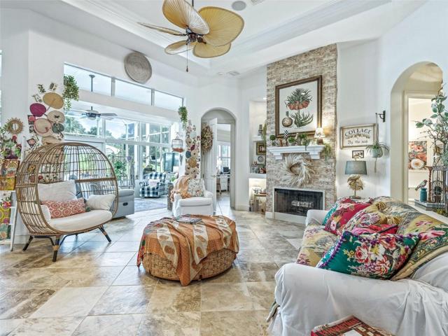Great room has fan, fireplace and ceiling moldings