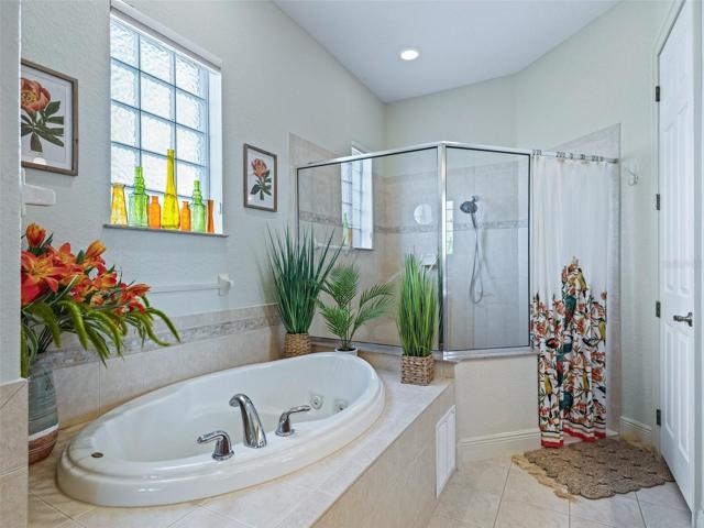 Primary bath has glass block for light and privacy
