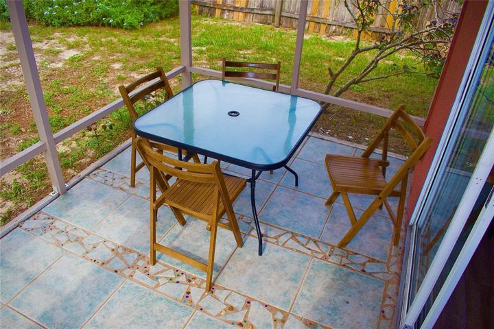 Screened in porch with marbles into the floor.