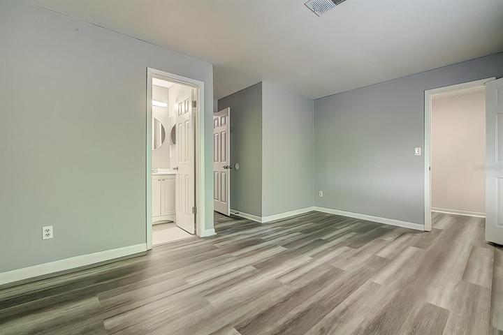 Primary with view of walk-in closet, ensuite